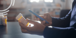 Patient using a smartphone to scan a prescription medication bottle during preoperative intake